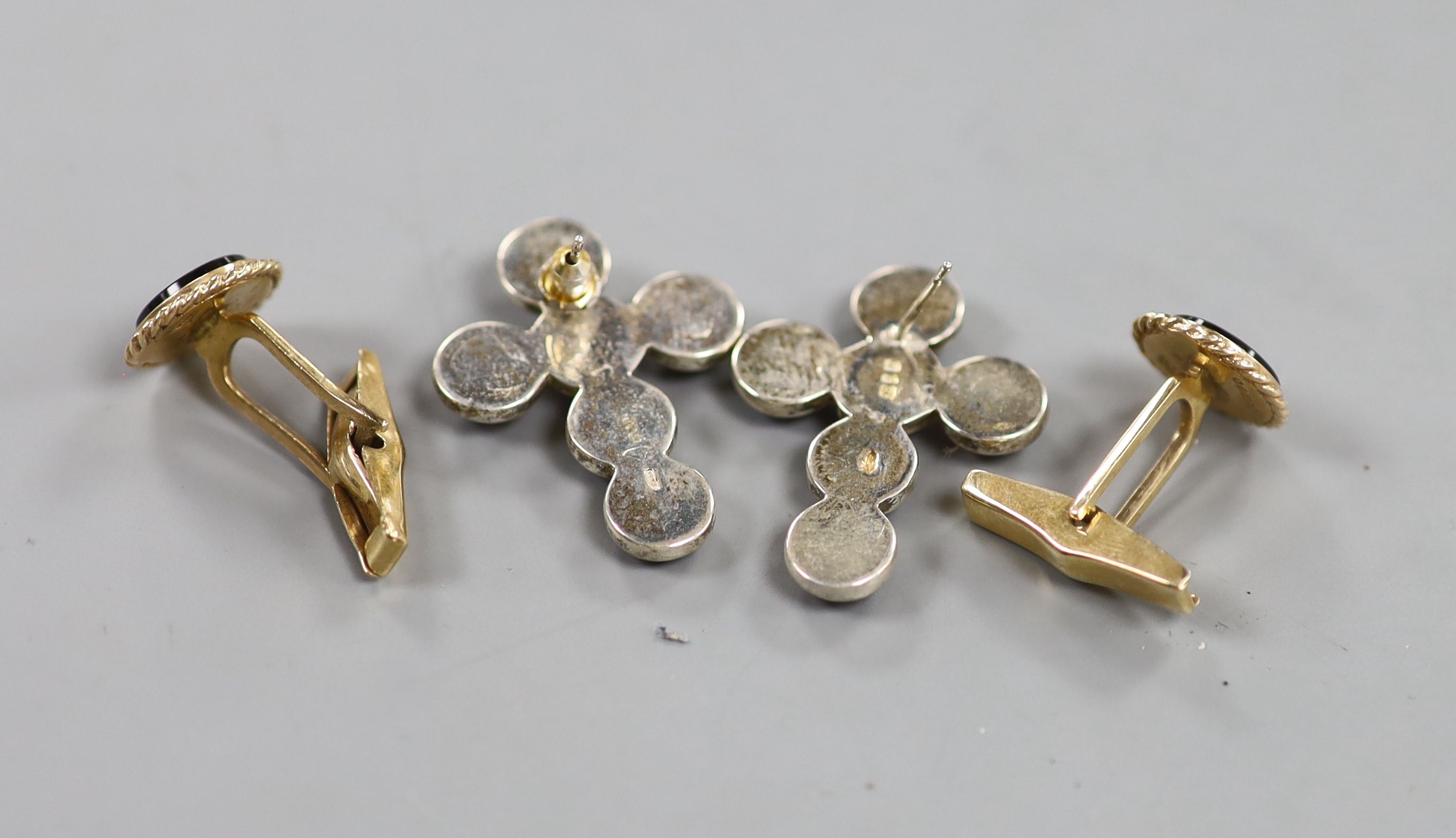 A pair of modern 9ct gold and black onyx set circular cufflinks, diameter 13mm, gross 6.7 grams and a pair of silver and cabochon amethyst set cross ear studs (one butterfly missing).